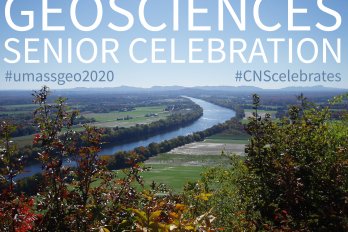 The popular scene of the Connecticut River winding its way south through farm fields towards the profile of the Holyoke Range on a clear blue-sky day with the words "GEOSCIENCES SENIOR CELEBRATION" and hashtags mentioned in tasteful white and blue text hanging in clear blue sky.