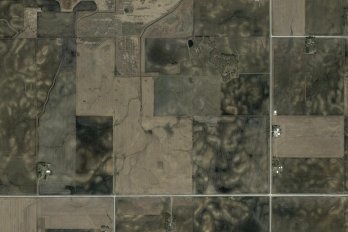 The agricultural landscape south of Clear Lake, Iowa. The light-colored patches in plowed fields are areas where dark-colored, organic-rich topsoil has been lost to erosion. Image courtesy GoogleEarth.