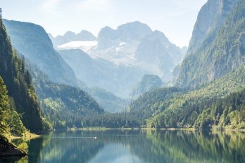 Mountain lake among jagged peaks and alpine forest in Austria