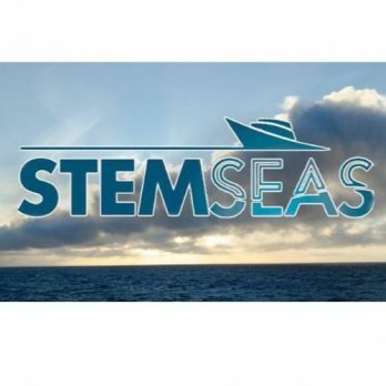 STEMSEAS logo in front of flat, dark blue ocean and white clouds in blue sky near sunset