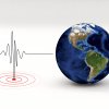 Image of earthquake seismograph next to blue-marble style globe.