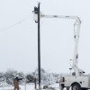 Linemen work to restore power in Texas during winter storm, February 2021. Photo by Jonathan Cutrer, via Flickr [CC BY-NC 2.0] 