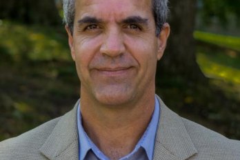 Headshot of Dr. Mike Rawlins in front of forested background