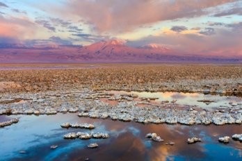 Alpenglow on distant mountain peaks bordering the Salar de Atacama