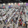 Photograph looking down on the poster hall of the 2018 AGU fall meeting, with several hundred people congregated in multiple rows of poster-stands, looking at what is hung on them.