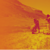 Yellow-Orange tone black and white photo of students conducting fieldwork in desert